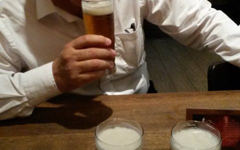 nigel holding a pint with two pints in front of him