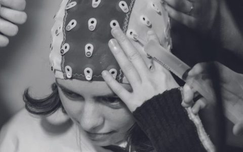 An LSO audience member wearing an EEG Electrode Cap, to measure brain activity while listening to the music