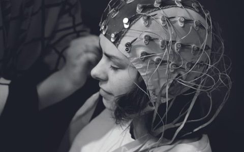An LSO audience member wearing an EEG Electrode Cap, to measure brain activity while listening to the music
