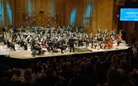 Musicians on the stage of the Barbican Hall.