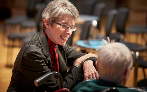 Kathryn speaking to an elderly member of the community