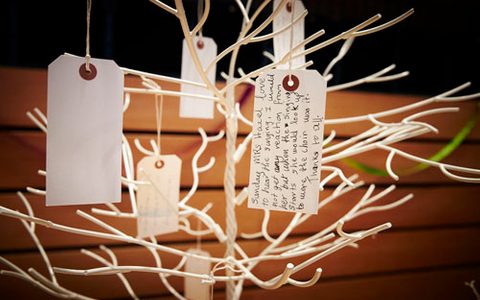 written note tags hanging off of a leafless tree