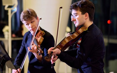 Two violinist performing.