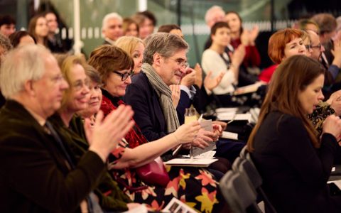 People applauding a perfromance.