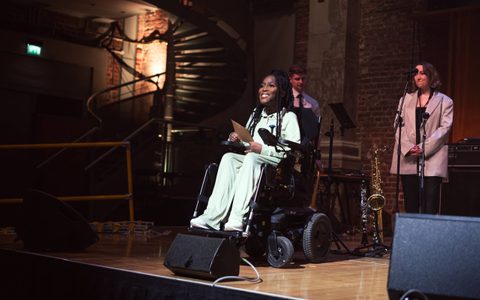 a person in a wheelchair presenting a concert at LSO St Luke's.