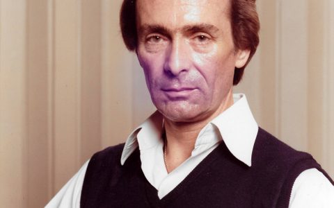 Portrait of Kurt-Hans Goedicke, wearing a white shirt under a dark vest, facing the camera with a serious expression.