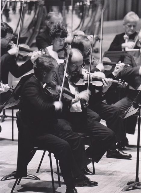 A young Nigel playing on stage with the orchestra
