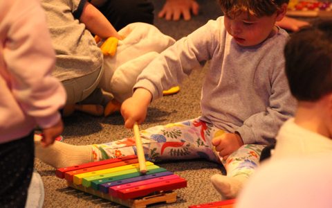 Under-5 playing with musical instrument