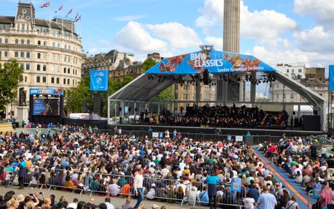The BMW Classics stage in Trafalgar Square with a crowd sat in front