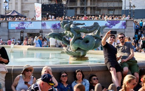 Audience members taking selfies at BMW Classics 2023 in Trafalgar Square