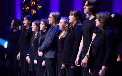Young people singing on stage