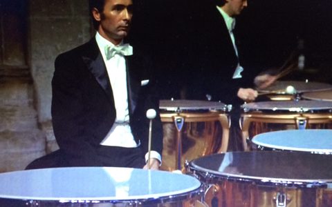 Kurt-Hans Goedicke and a percussion player in formal attire playing timpani during a concert.