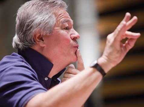 patrick turned to the side with his right hand in the air and his left pointer finger on his mouth