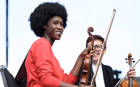 An LSO Discovery violin player sat onstage at BMW Classics.