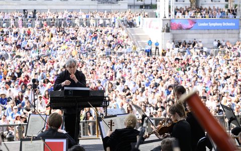 Sir Antonio Pappano conducting the LSO with his right pointer finger over his lip and the audience in the background at BMW Classics 2025 in Trafalgar Square, London