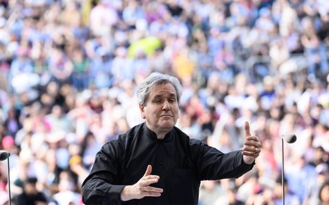 Close up shot of Sir Antonio Pappano conducting the LSO with both his hands up, his right arm higher at BMW Classics 2025 in Trafalgar Square, London