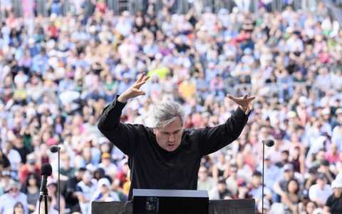 Close up shot of Sir Antonio Pappano conducting the LSO with both arms above his head with a serious expression on his face at BMW Classics 2025 in Trafalgar Square, London